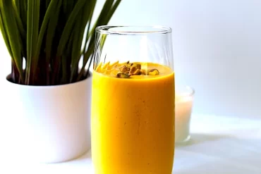 Beautiful bright orange, thick yogurt-based drink. A Cardamom Spiced Mango Lassi