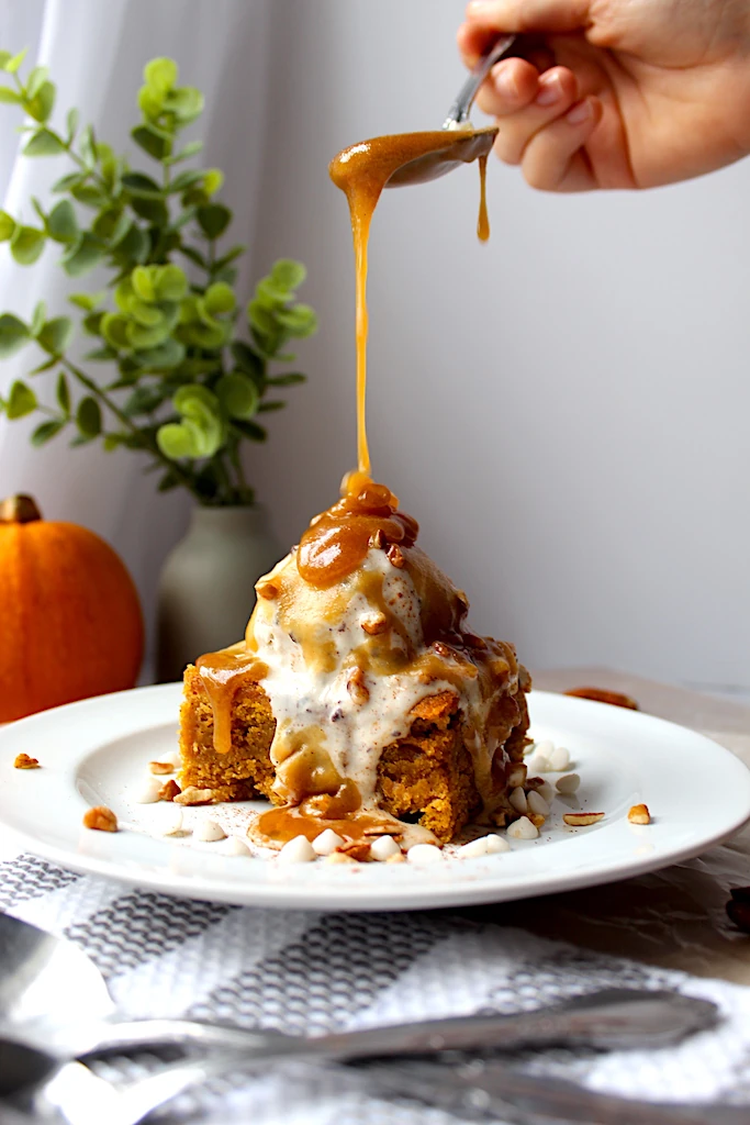 Drizzling gorgeous maple-butter sauce onto vanilla base ice cream.