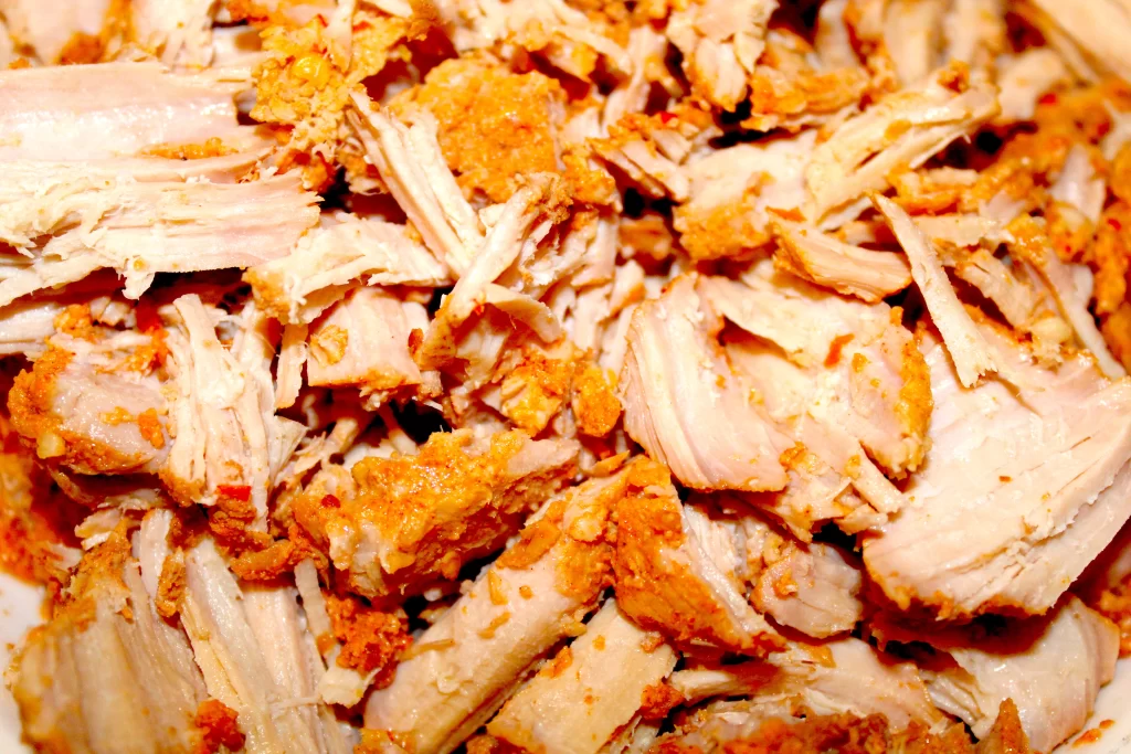 Shredded pork that has been slow roasted in Portuguese Marinade. It is slightly red, juicy, and very spicy.