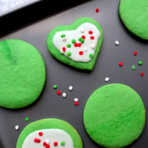 A sheet pan of grinch cookies displays from above the adorable decorations done by my grinch-loving kids.