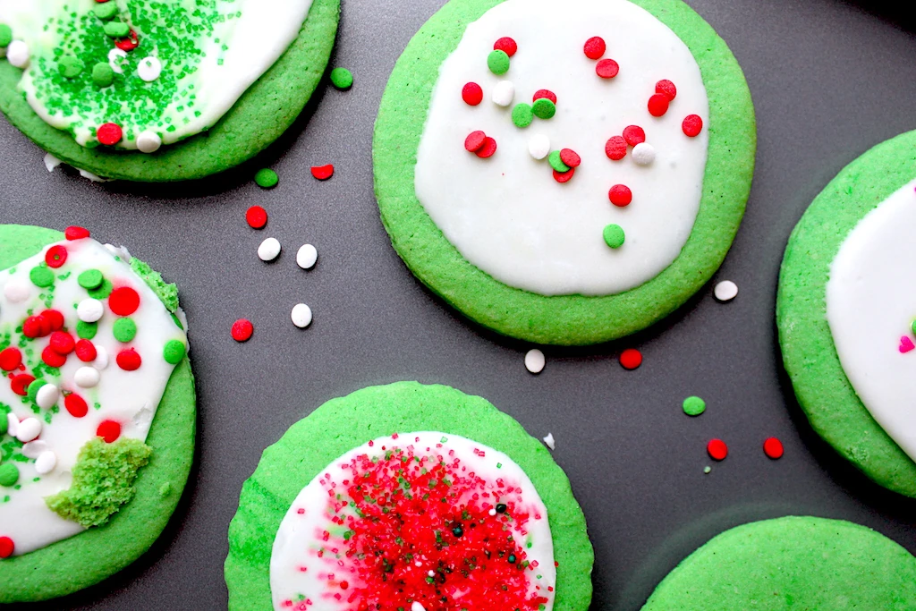 a sheet of adorably decorated grinch cookies. The kids chipped in on this recipe!