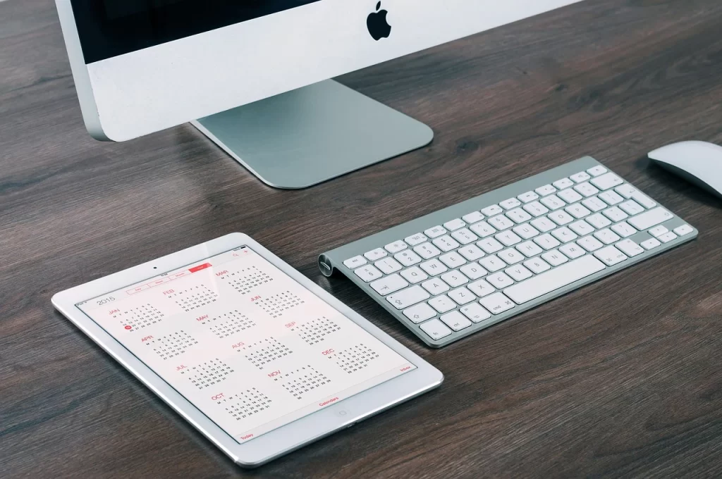 A clean white keyboard, and iPad are shown.