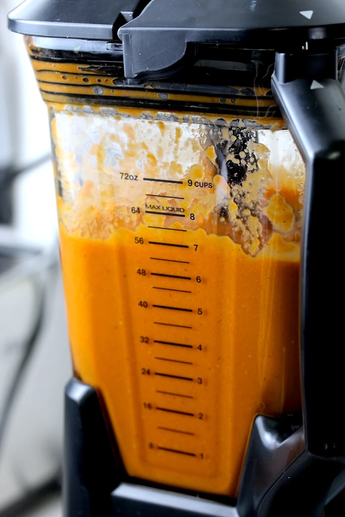 A blender filled with freshly roasted soup.