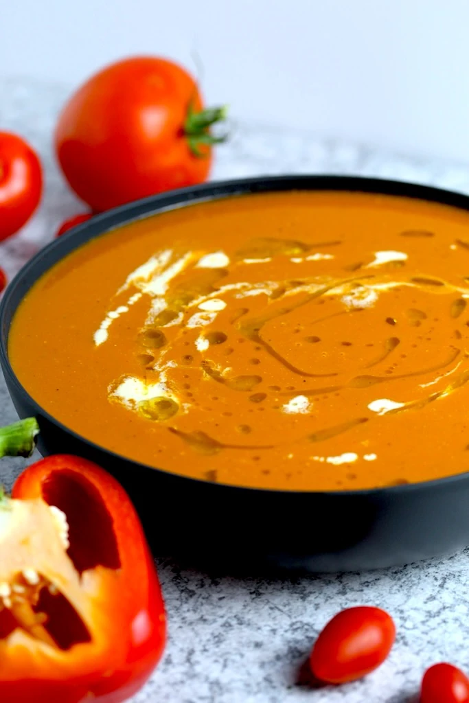 Gorgeous red roasted tomato soup, drizzled with olive oil and cream.